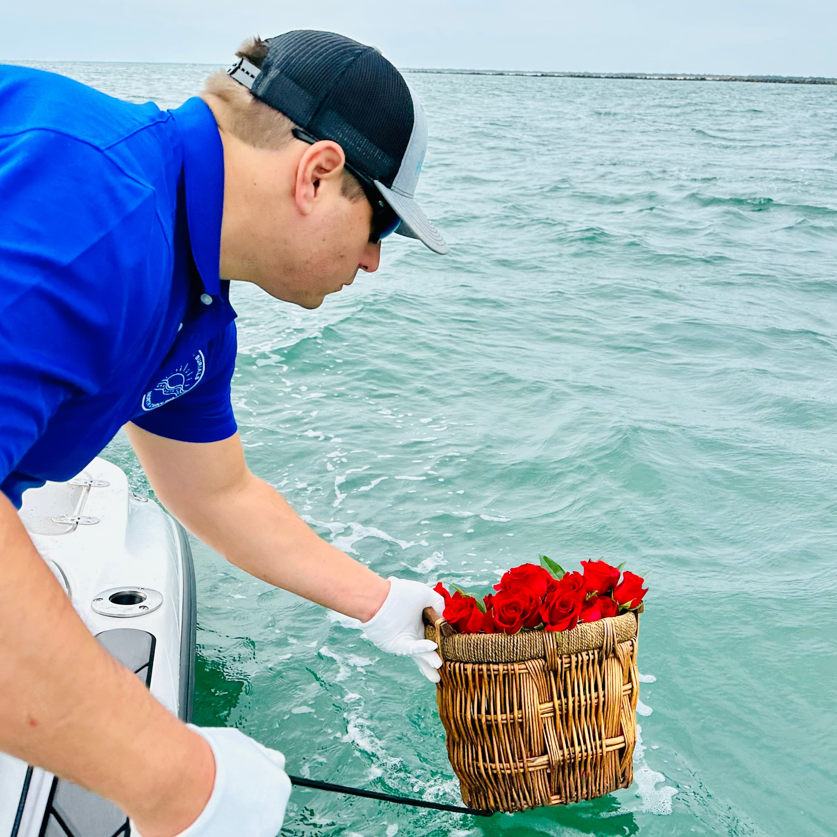 Captain carefully lowering a memorial basket