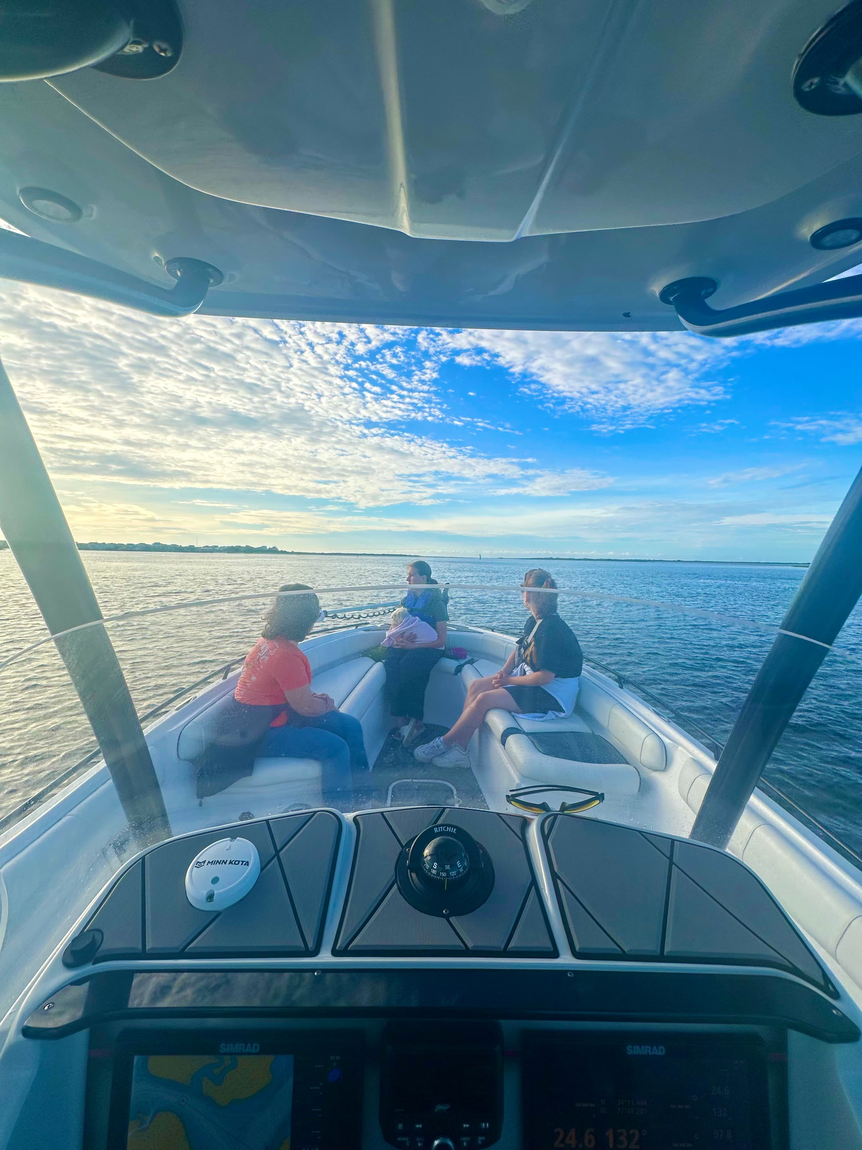 Family aboard the vessel during an attended sea burial ceremony at sunset
