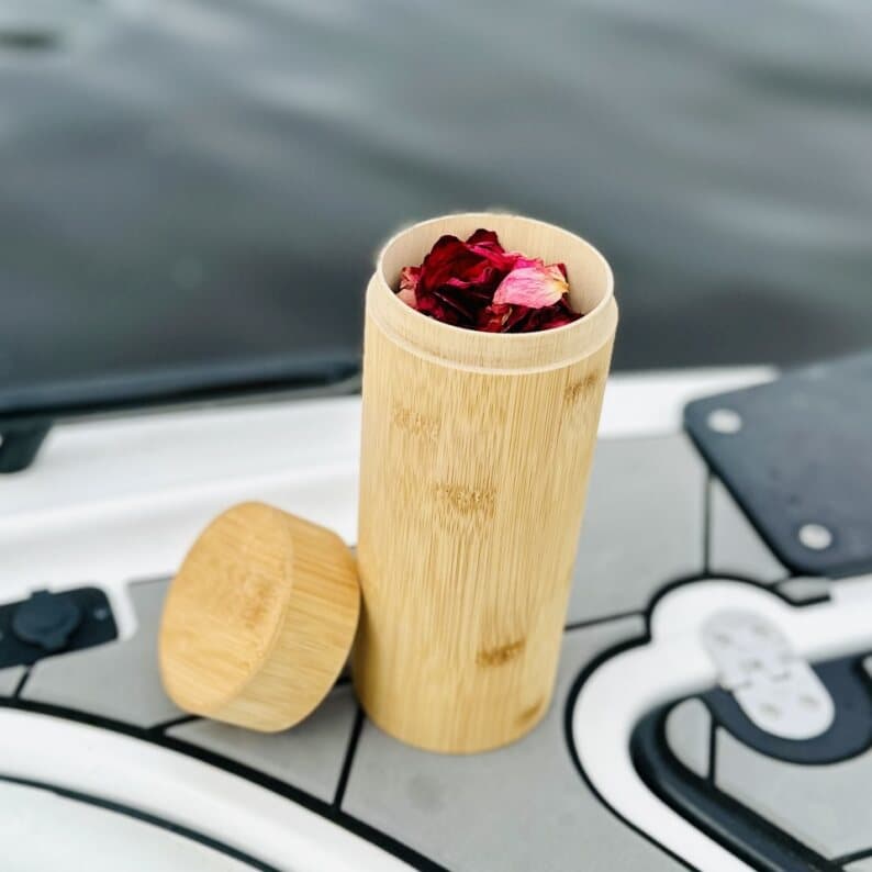 Open bamboo urn filled with rose petals on the vessel