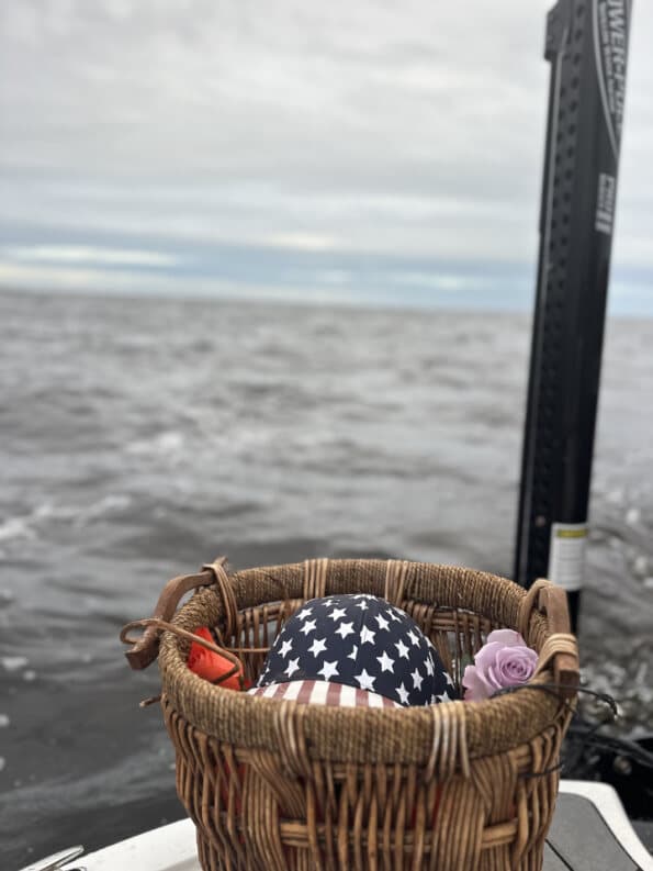 Memorial basket with American flag and purple rose before scattering