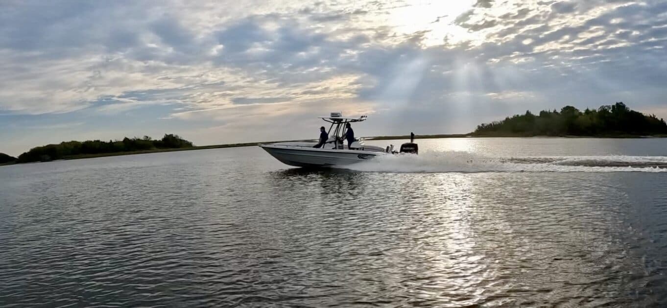 The Serene vessel underway with sunlight breaking through clouds